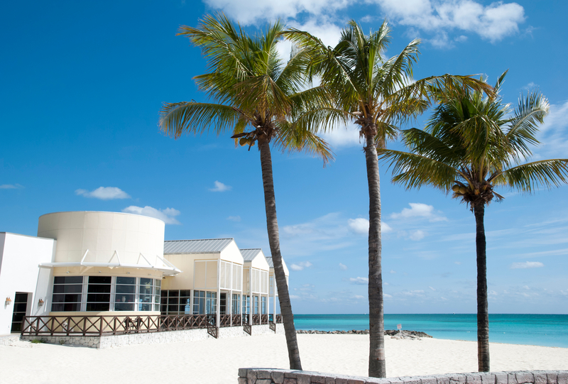 Palm trees and beach side restaurant on Lucaya Beach, Grand Bahama, Bahamas