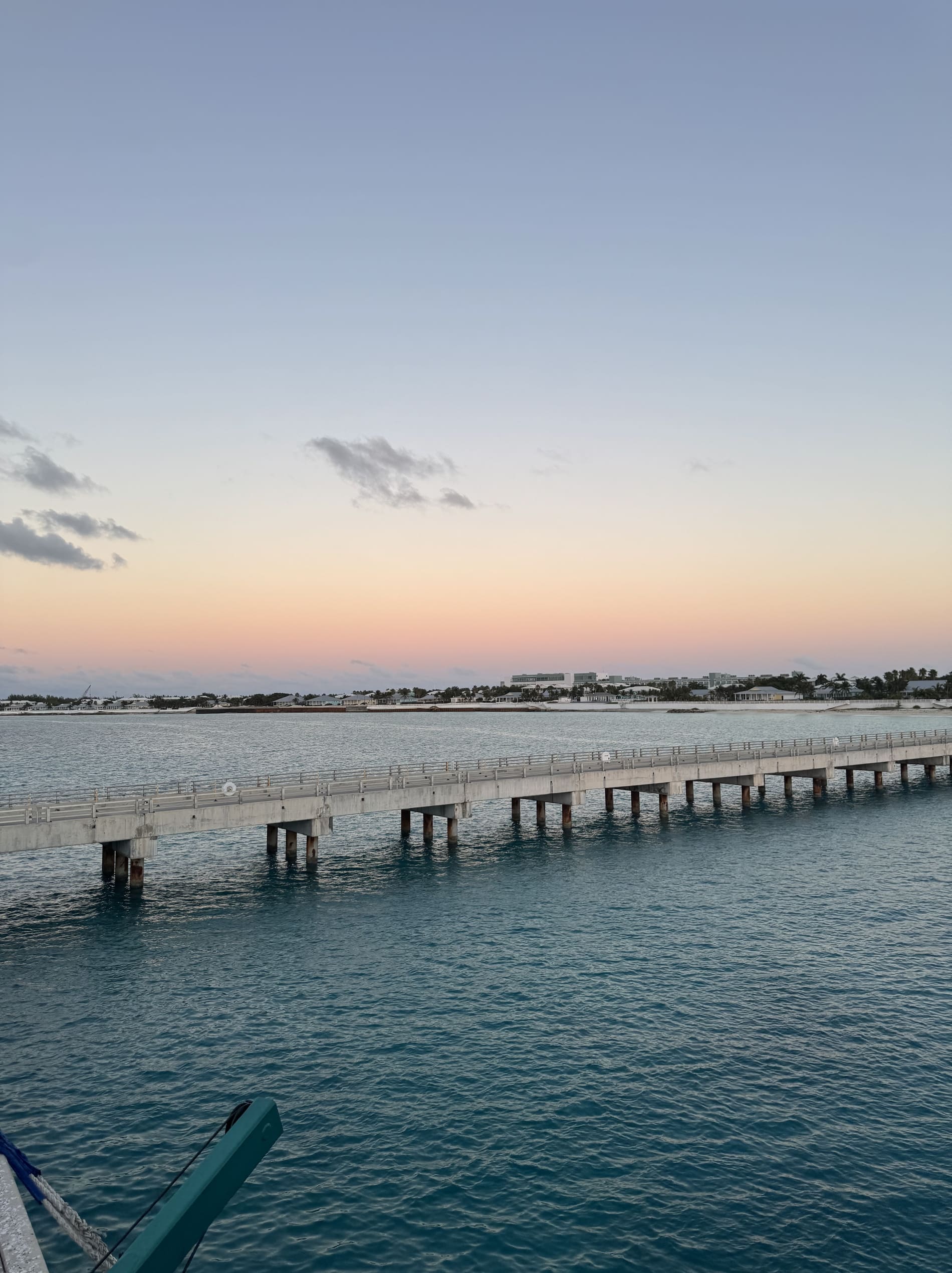 Treasure Cay beach with a dock during dusk in Abaco, Bahamas